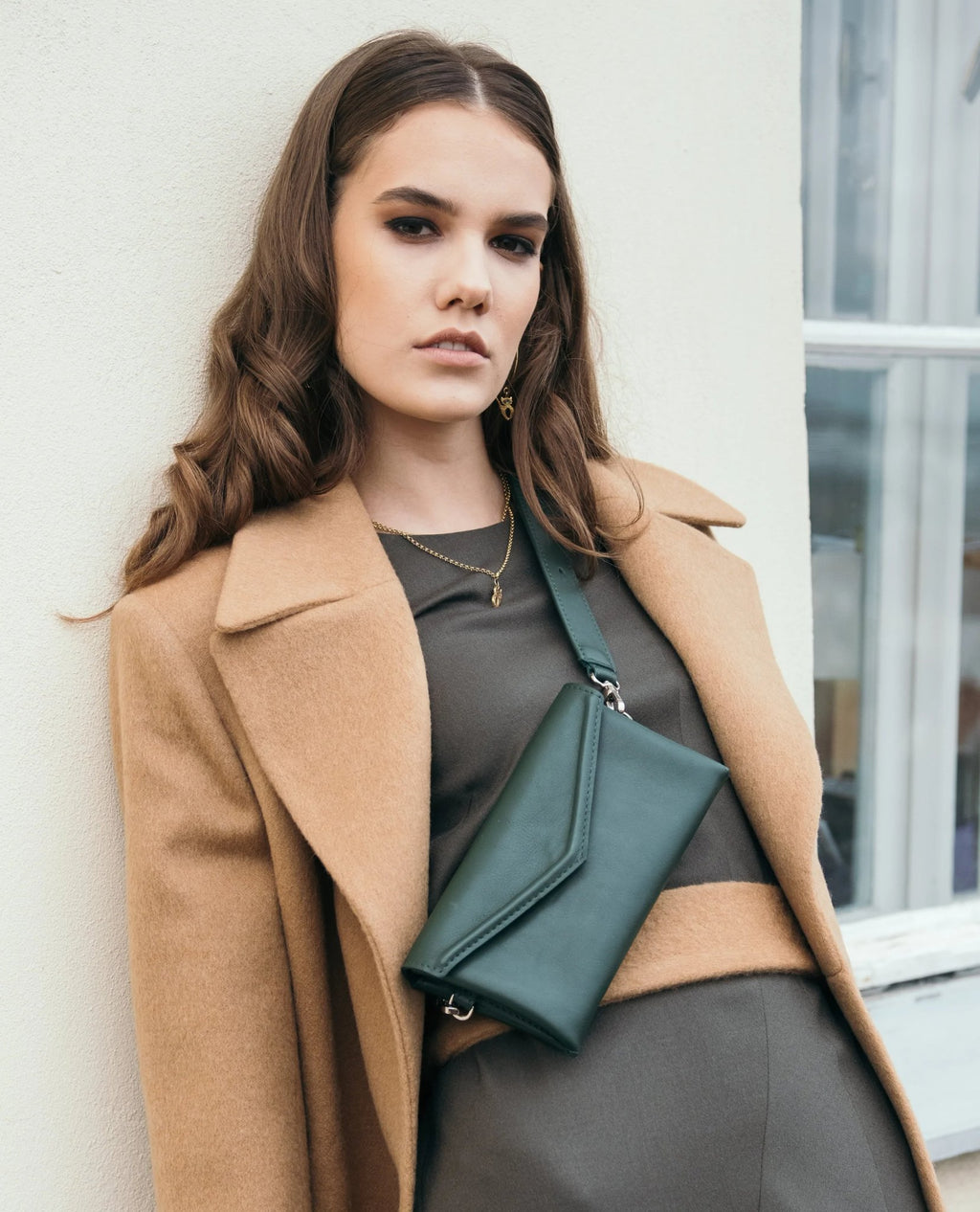 4. Women's green Gerda Retter shoulder bag styled with camel coat in city setting