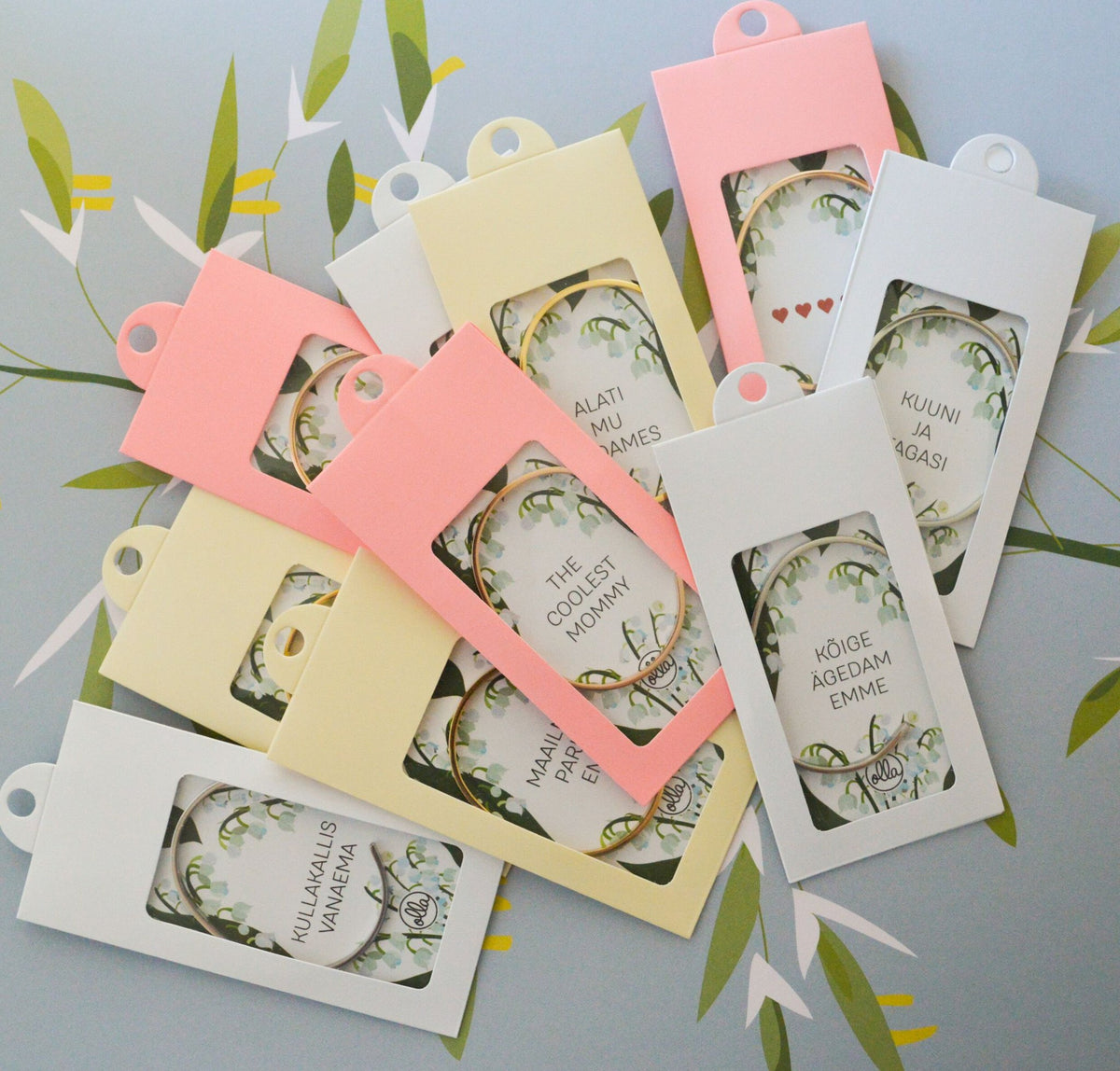 3. Assorted packaging for 'The Coolest Mommy' bracelet by Olla, featuring various designs