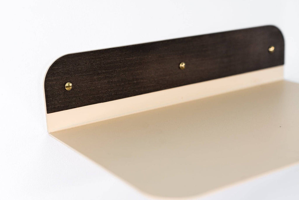 3. Close-up of beige wall-mounted shelf with rounded edges and wooden back, by Ewart Woods