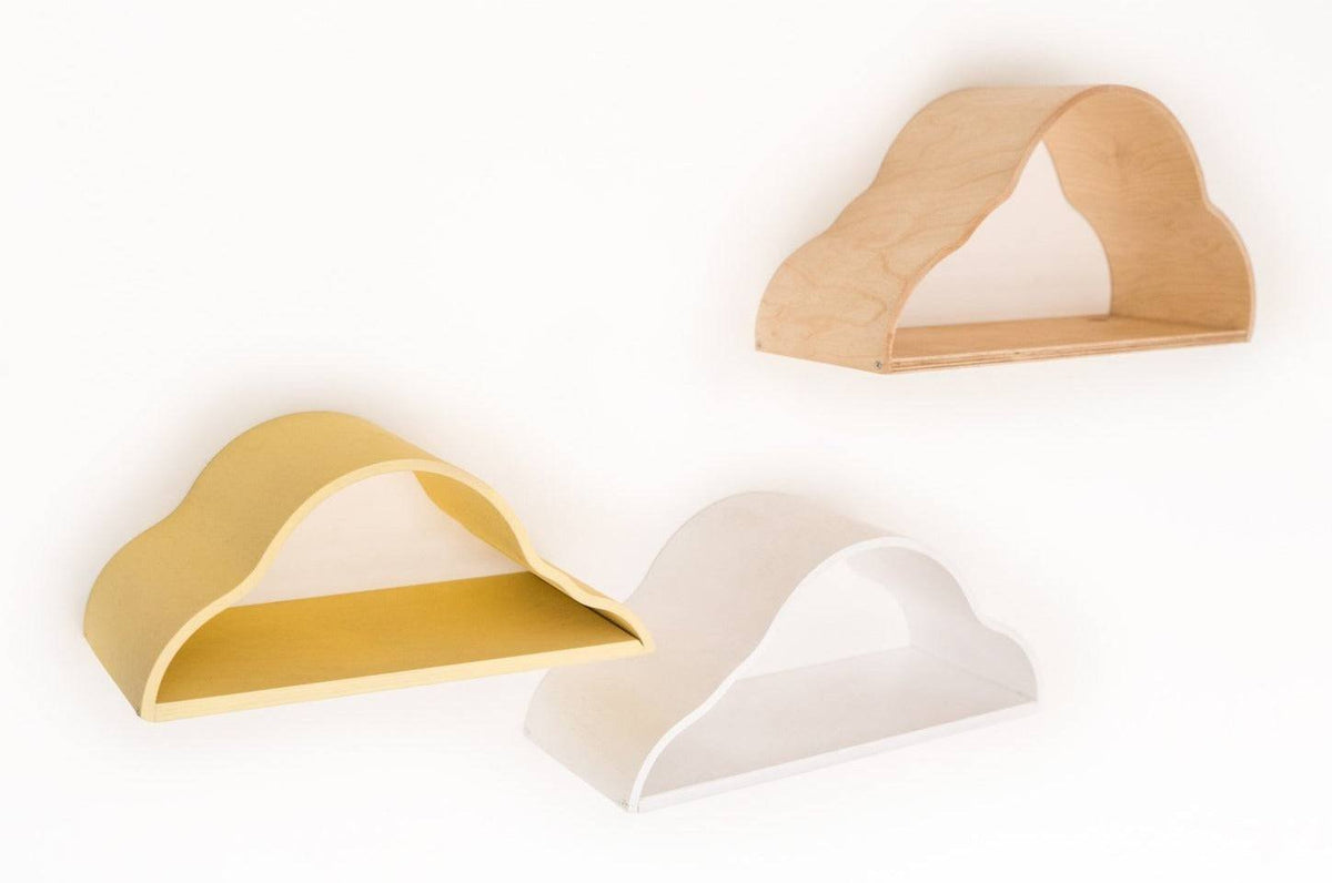 2. Set of three cloud-shaped floating shelves in white, yellow, and natural wood colors mounted on a white wall.