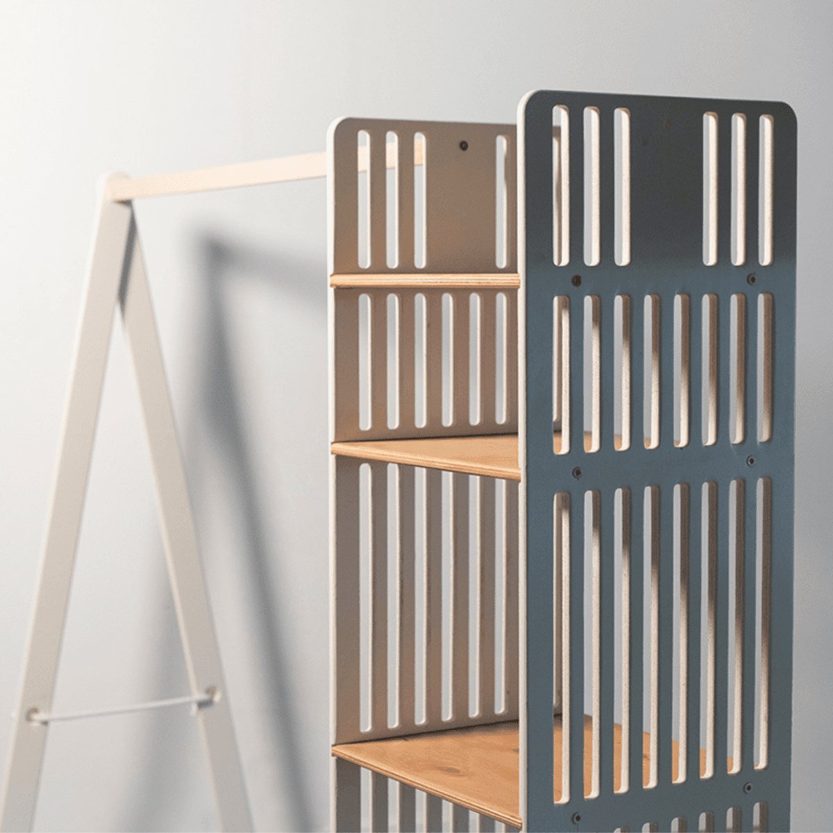 2. Close-up of Ewart Woods kids wooden clothing rack showing slatted storage shelves and light wood finish