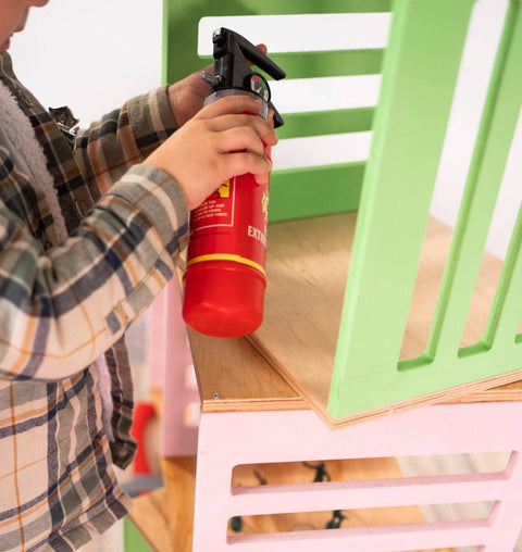 3. Detail of child interacting with green and pink wooden storage cubes by Ewart Woods