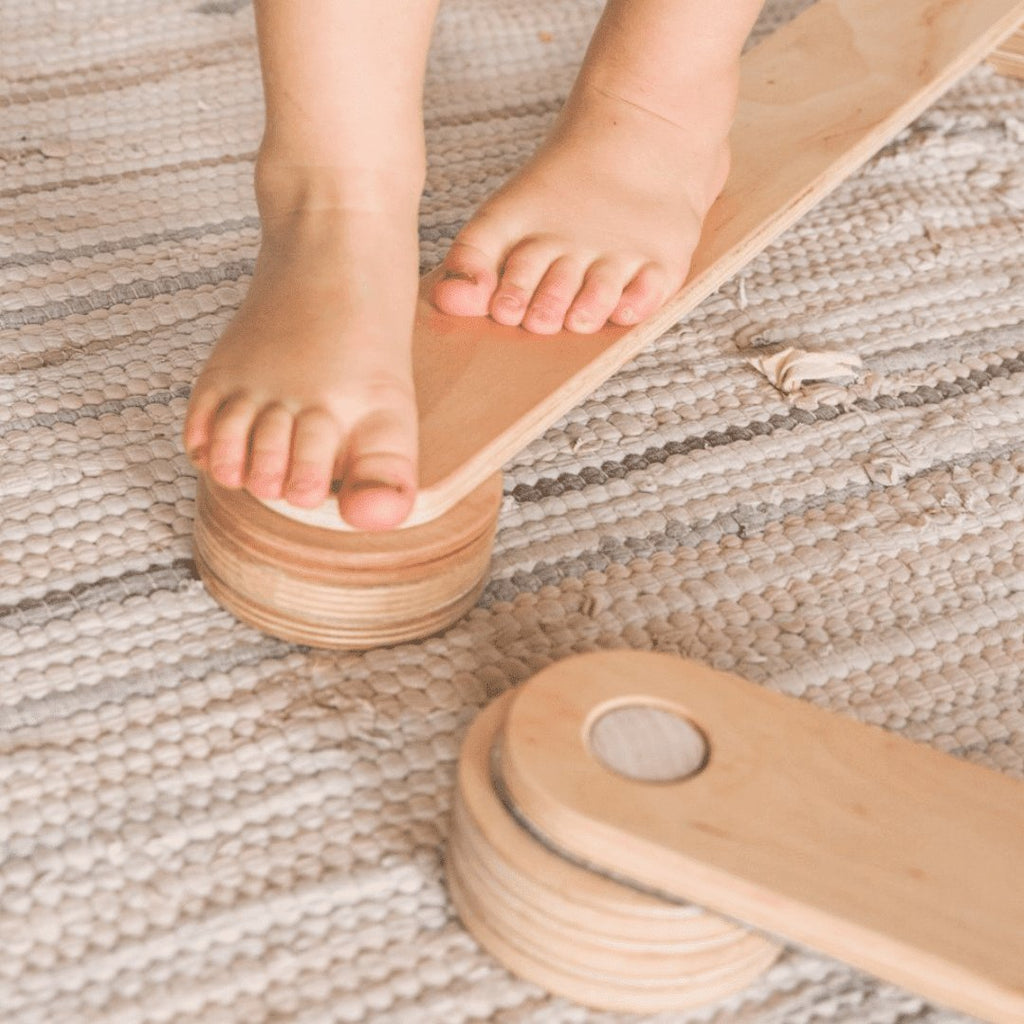 8. Close-up of child's feet on Ewart Woods wooden balance beam