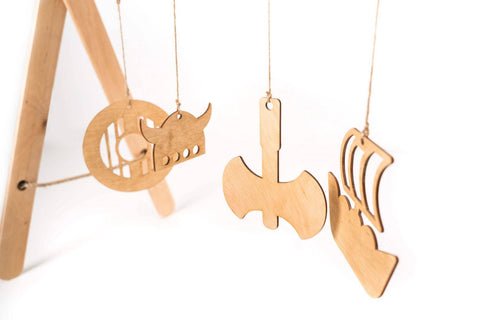 4. Close-up of Viking-themed wooden hanging toys on baby play gym