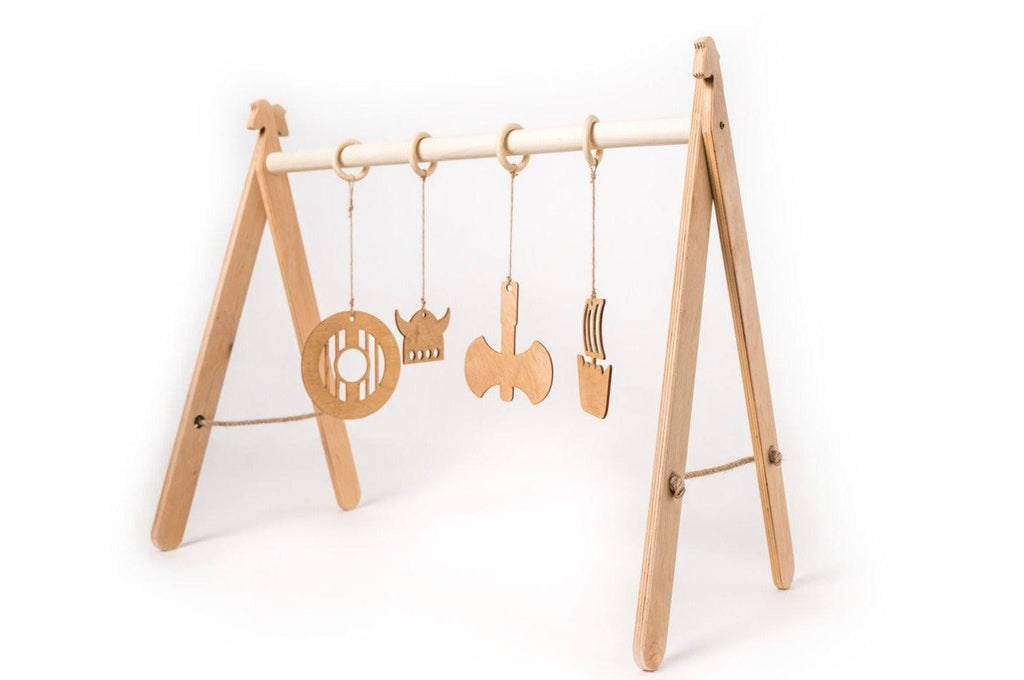2. Wooden baby play gym with Viking-themed hanging toys on a white background