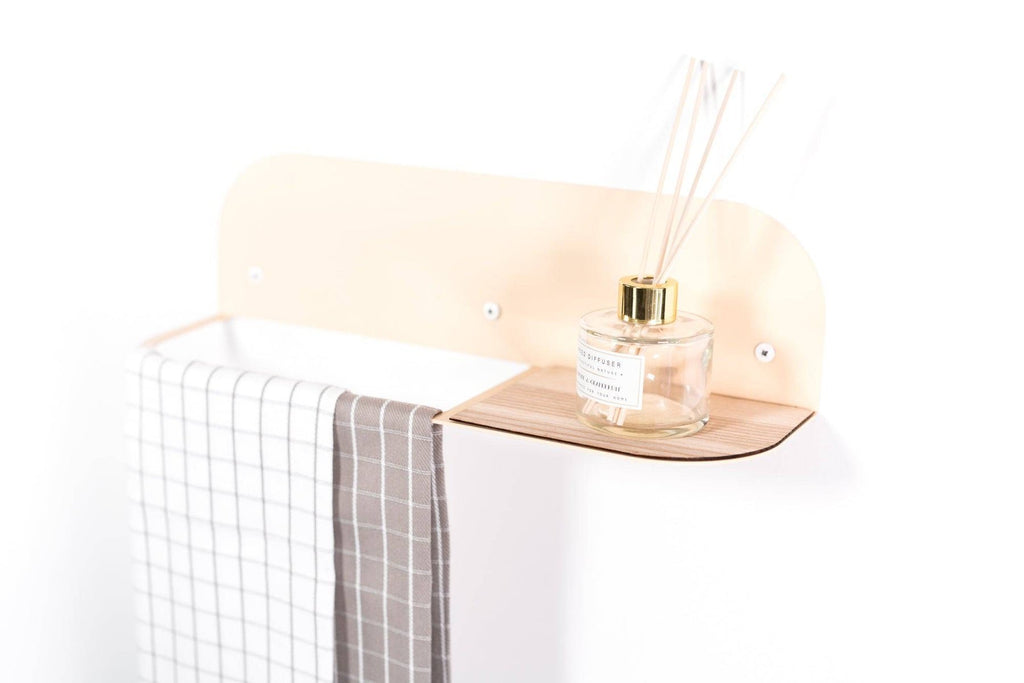 2. Close-up of beige towel rack with checkered towel and diffuser on wooden shelf, mounted on white wall