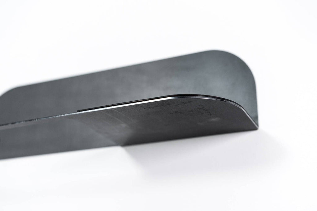 3. Close-up of black steel edge of towel rack showing smooth curved design