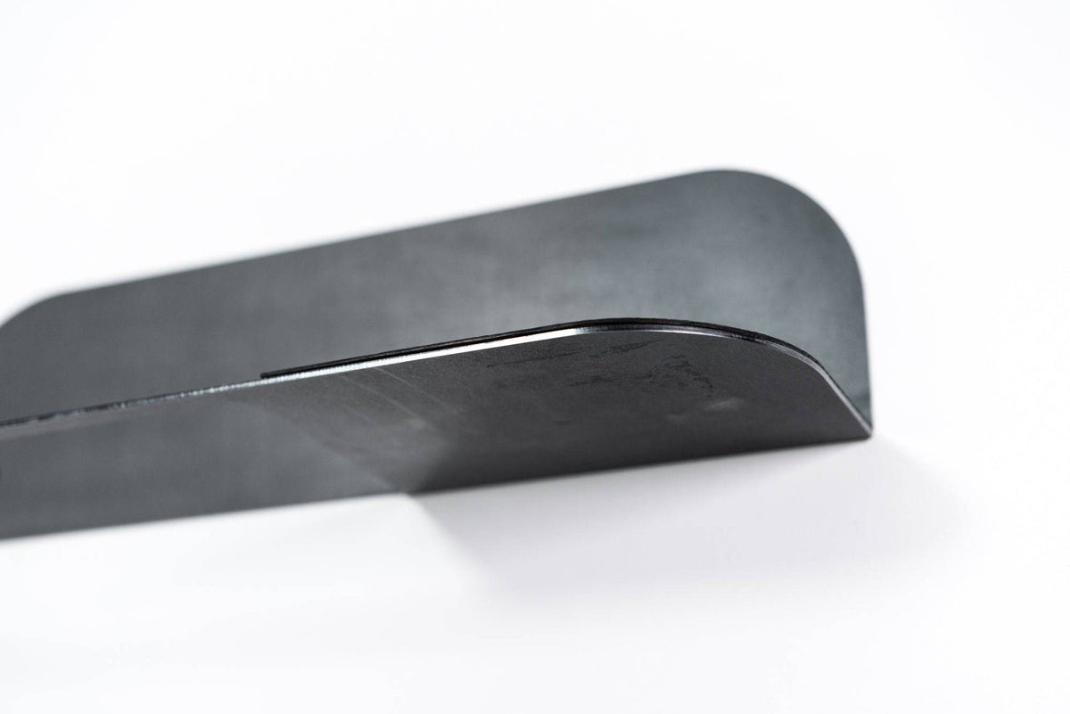 3. Close-up of black steel edge of towel rack showing smooth curved design