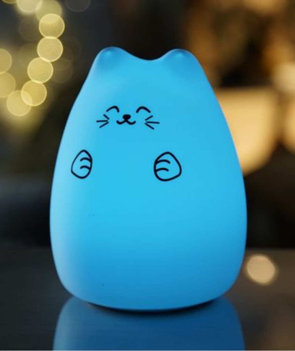2. Blue glowing Lucky Cat silicone lamp on table with blurred lights in background