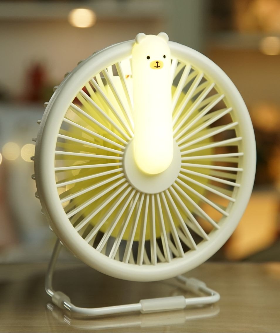 3. White Little Bear Fan Lamp with illuminated bear-shaped light, placed on a wooden surface indoors