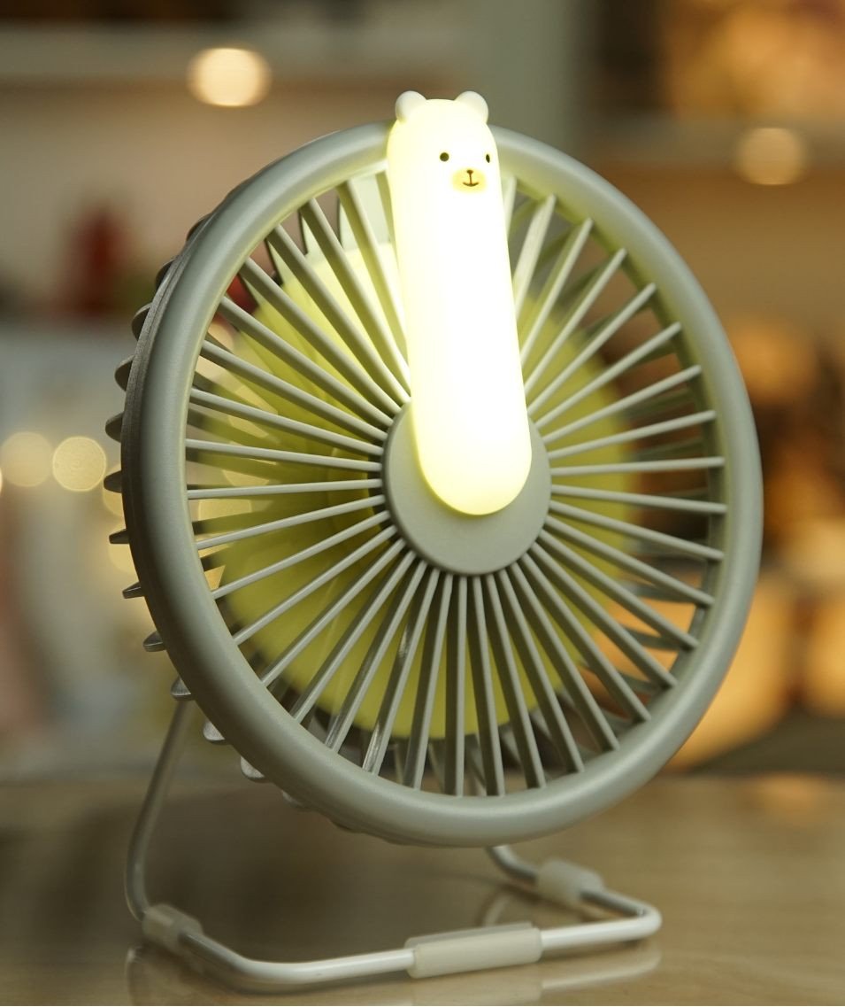 3. Close-up of grey Little Bear Fan Lamp with illuminated bear-shaped light in cozy indoor setting