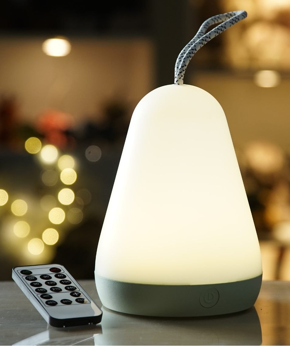 1. White lantern lamp with remote control glowing warmly in a cozy indoor setting with blurred lights