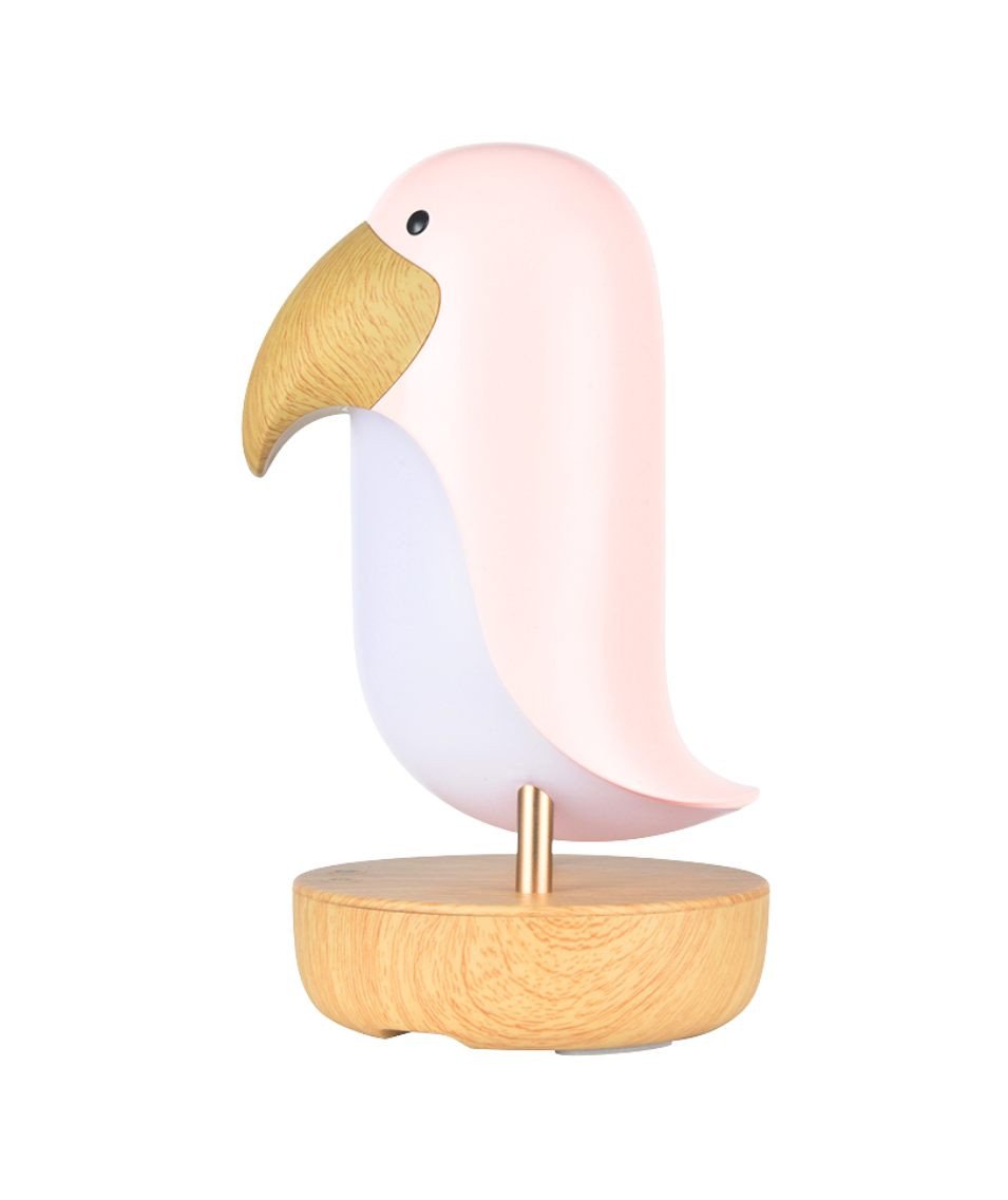 2. Pink bird-shaped lamp with wooden base shown in studio setting highlighting its sleek design