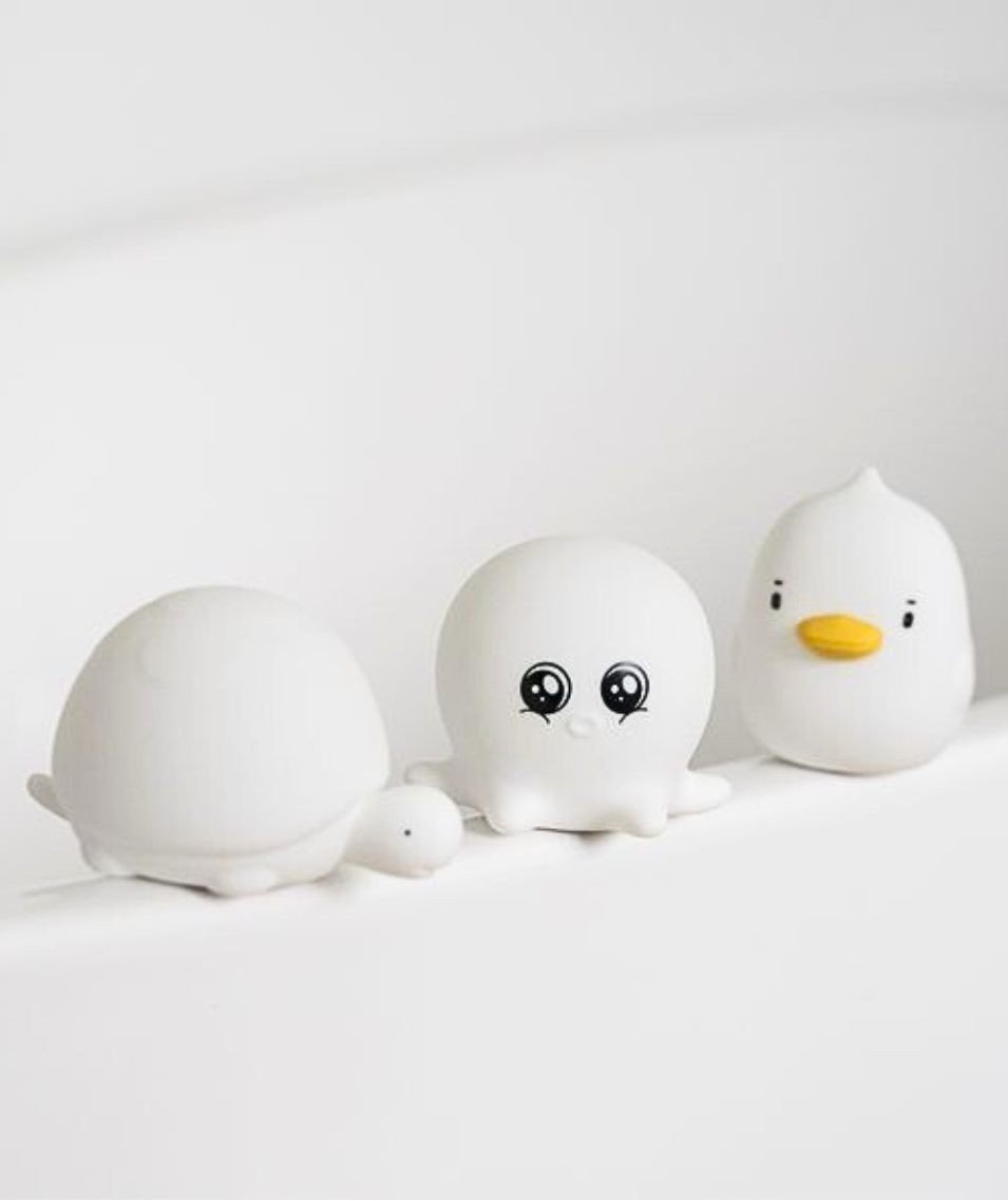 5. White silicone lamps in duck, octopus, and turtle shapes lined up on white surface