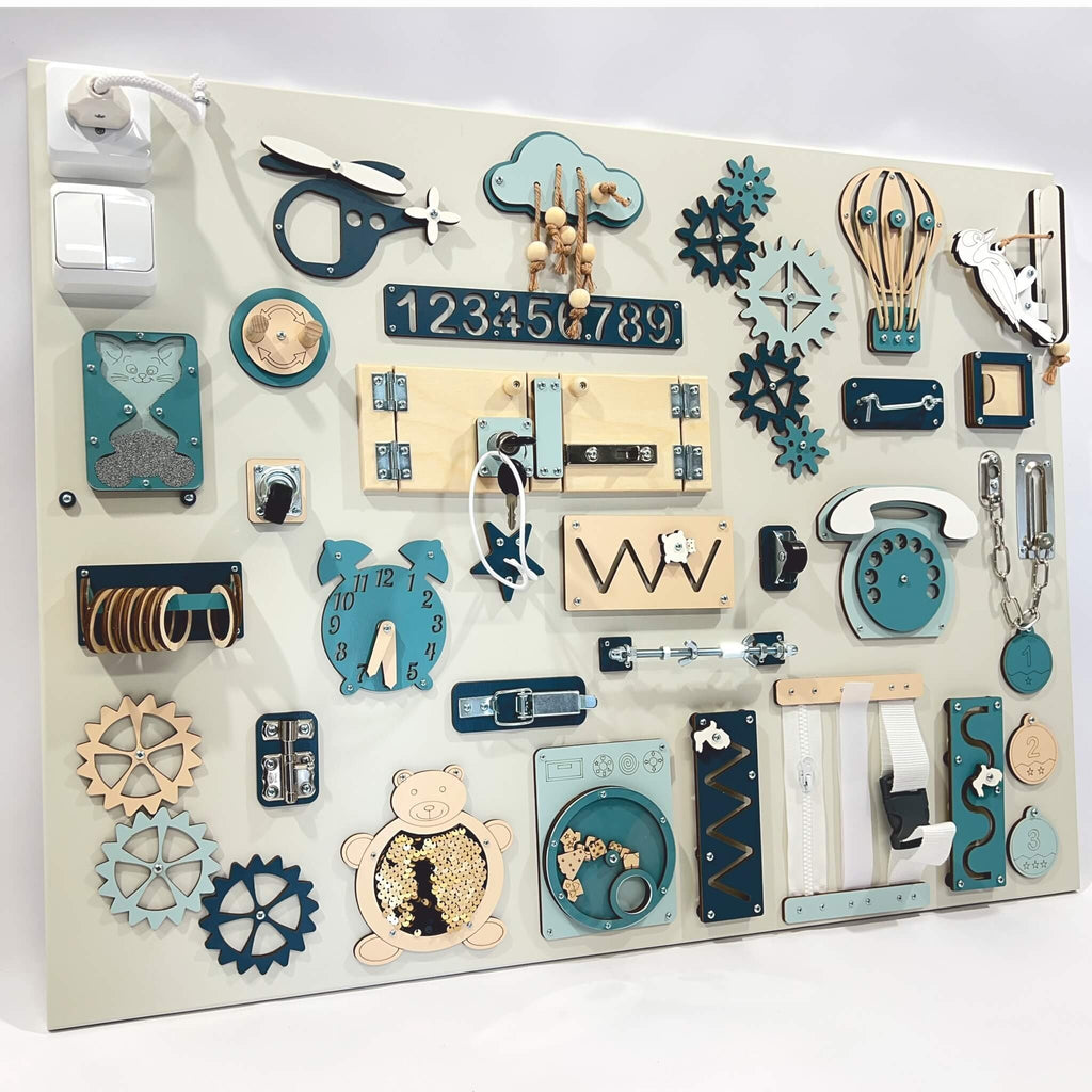 1. Extra large Montessori sensory busy board with various interactive elements in blue and beige tones, designed for skill building and sensory play, shown in a studio setting.