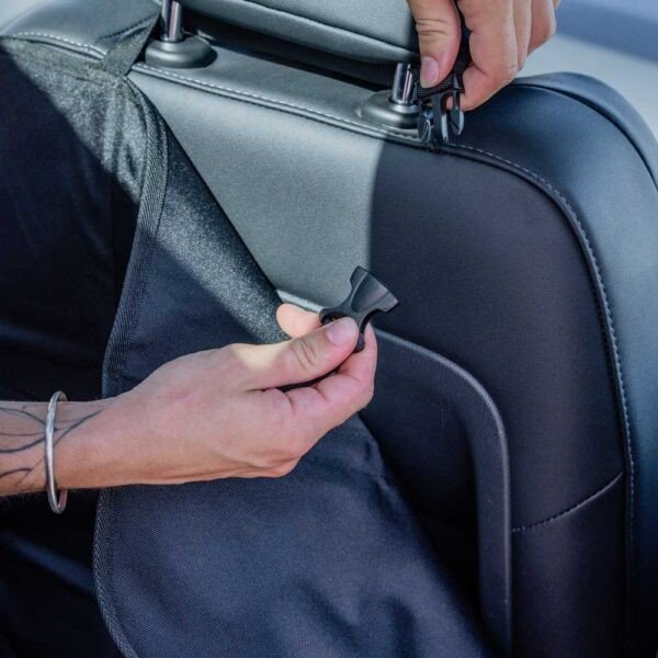 3. Close-up of hands adjusting Ezi Mat 3 in 1 seat protector straps on car seat