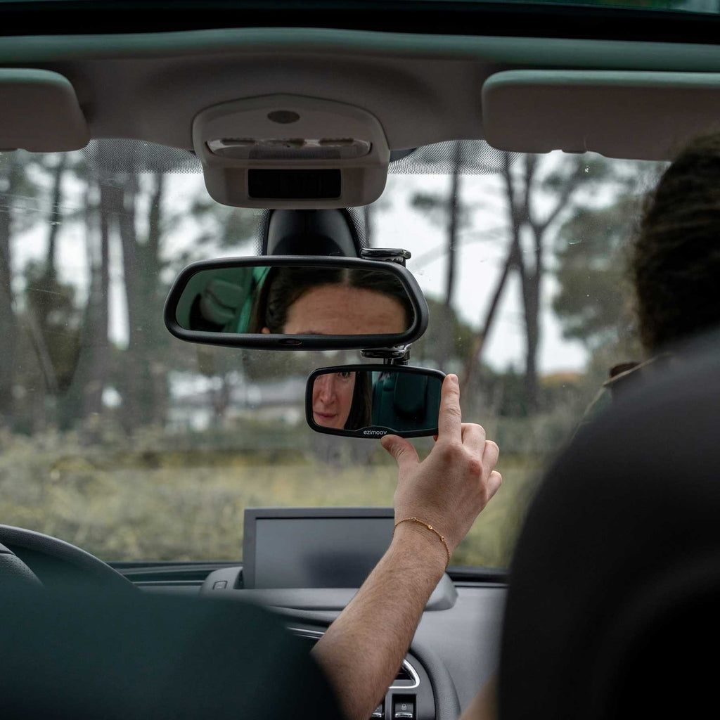 7. Person adjusting Ezimoov EZI Mirror Clip in car, showing rear view