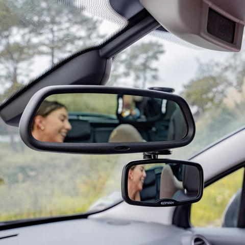1. Woman adjusting Ezimoov EZI Mirror Clip in car, showing rear seat reflection with child
