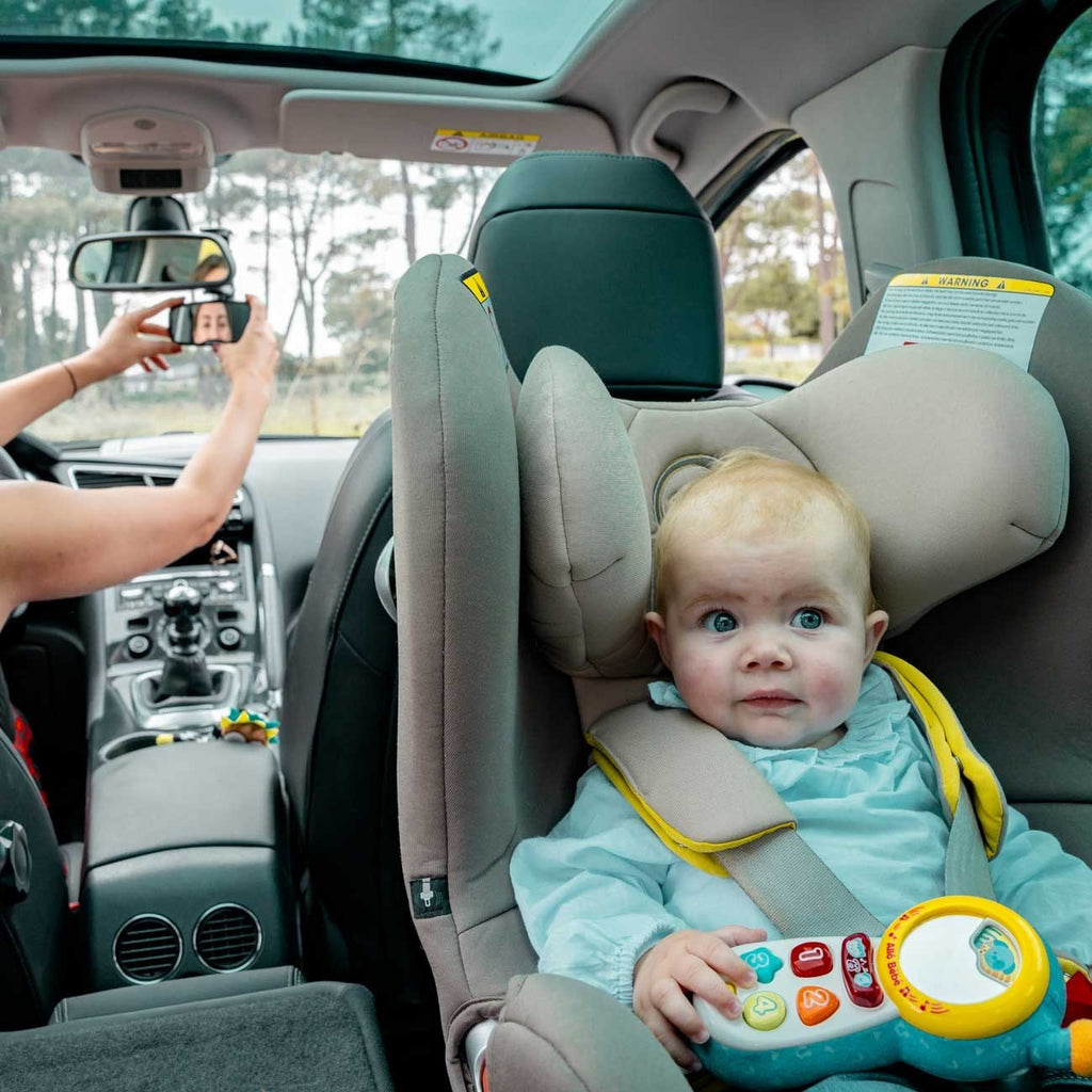 6. Baby in car seat with woman adjusting Ezimoov EZI Mirror Clip in front seat