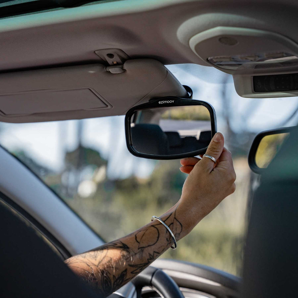 11. Person installing Ezimoov EZI MIRROR MINI on car sun visor