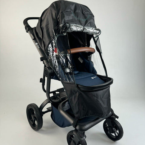 2. Ezimoov universal stroller rain cover on black stroller with clear windows and brown handle in studio setting