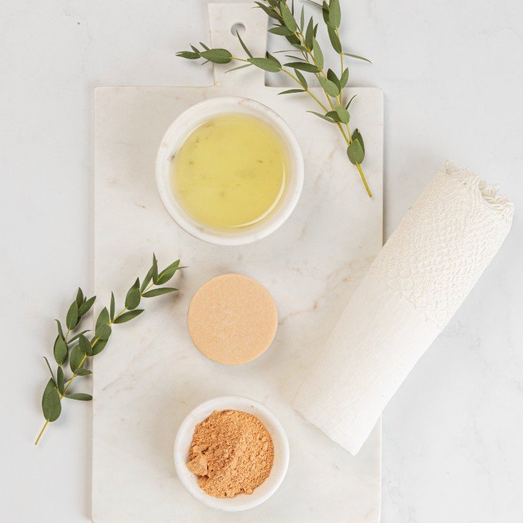 5. Flat lay of Vegan Fox Face Cleanser Bar with Pink Clay, oil, and clay powder