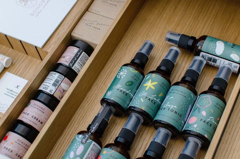 1. Collection of Bonobo skincare products including Lady's Mantle Face Tonic in wooden drawer, showcasing various bottles and jars