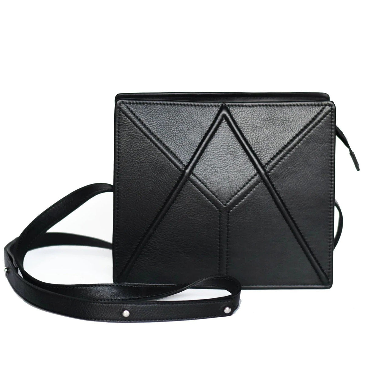 2. Studio image of black FACET shoulder bag by Gerda Retter Design, featuring geometric pattern and adjustable strap