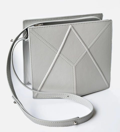 4. Grey FACET shoulder bag by Gerda Retter Design in studio setting, showing adjustable strap and geometric pattern
