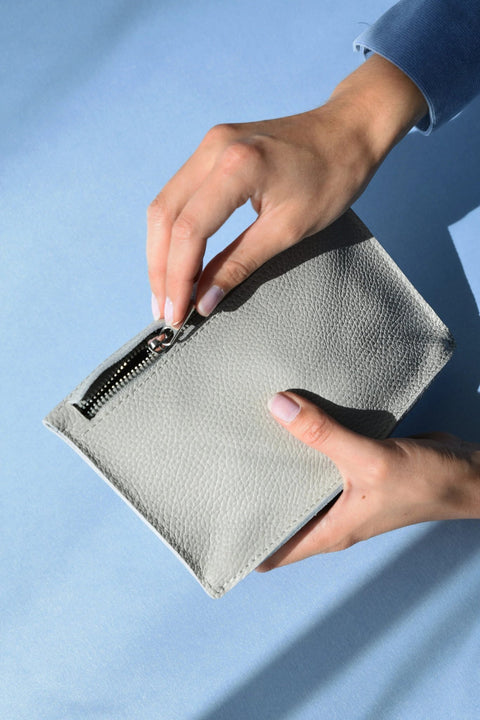 3. Close-up of Gerda Retter Design FACET Clutch in light grey, showing zipper detail and textured Spanish leather
