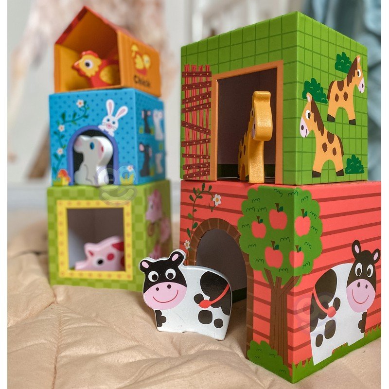 1. Colorful farm-themed cube puzzle with animal illustrations and wooden figurines on a beige surface