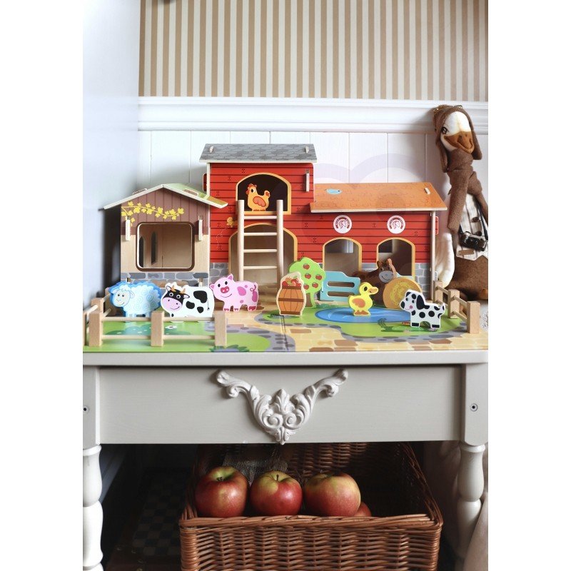 2. Woopie Green Mega Farm set displayed on a table, featuring barn, stable, and animal figurines with apples in basket below