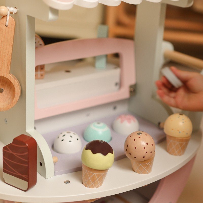 3. Close-up of pastel wooden ice cream cart with magnetic scoops and popsicles