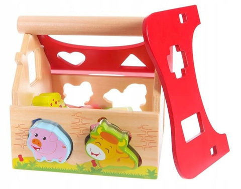2. Open wooden farmhouse shape sorter with red roof removed, showing animal shapes and cutouts for educational play