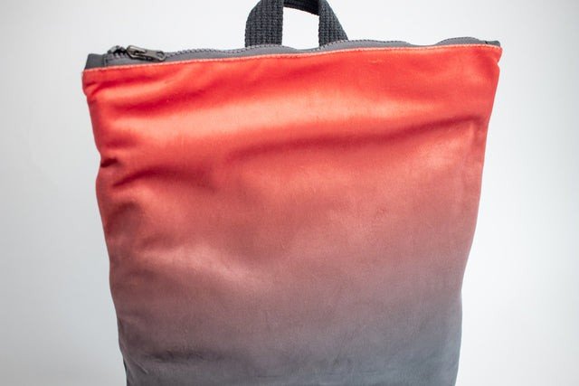 3. Close-up of Muni salmon faux leather backpack showing top zipper and handle