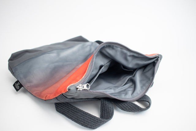 3. Interior view of Muni salmon faux leather backpack showing grey lining and zipper