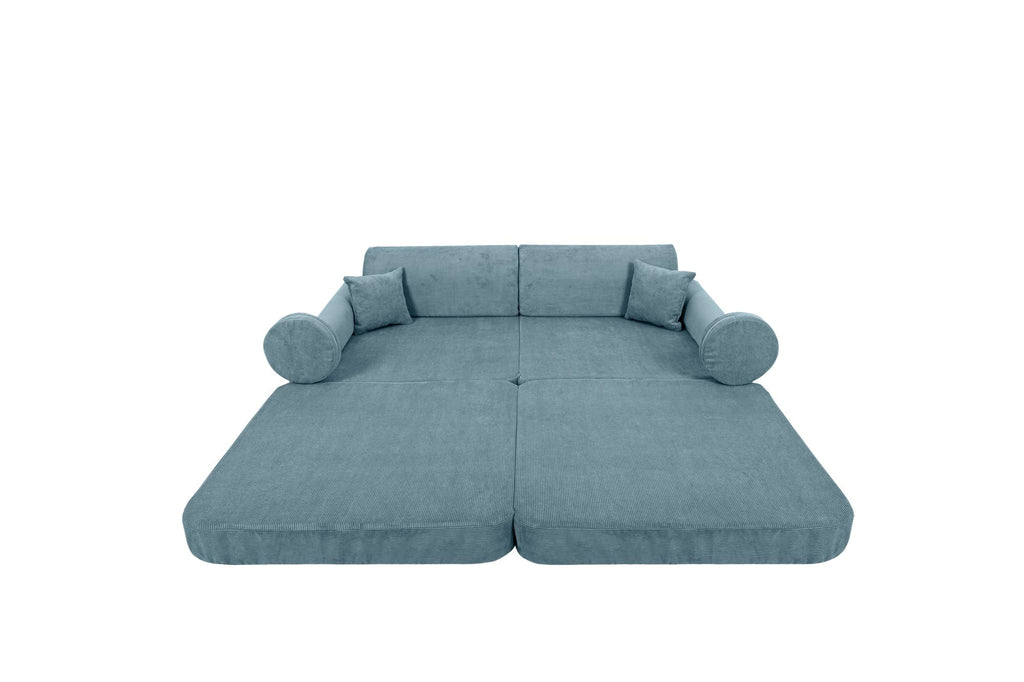 1. Large modular children's sofa in turquoise corduroy, laid flat with cylindrical cushions on a black background