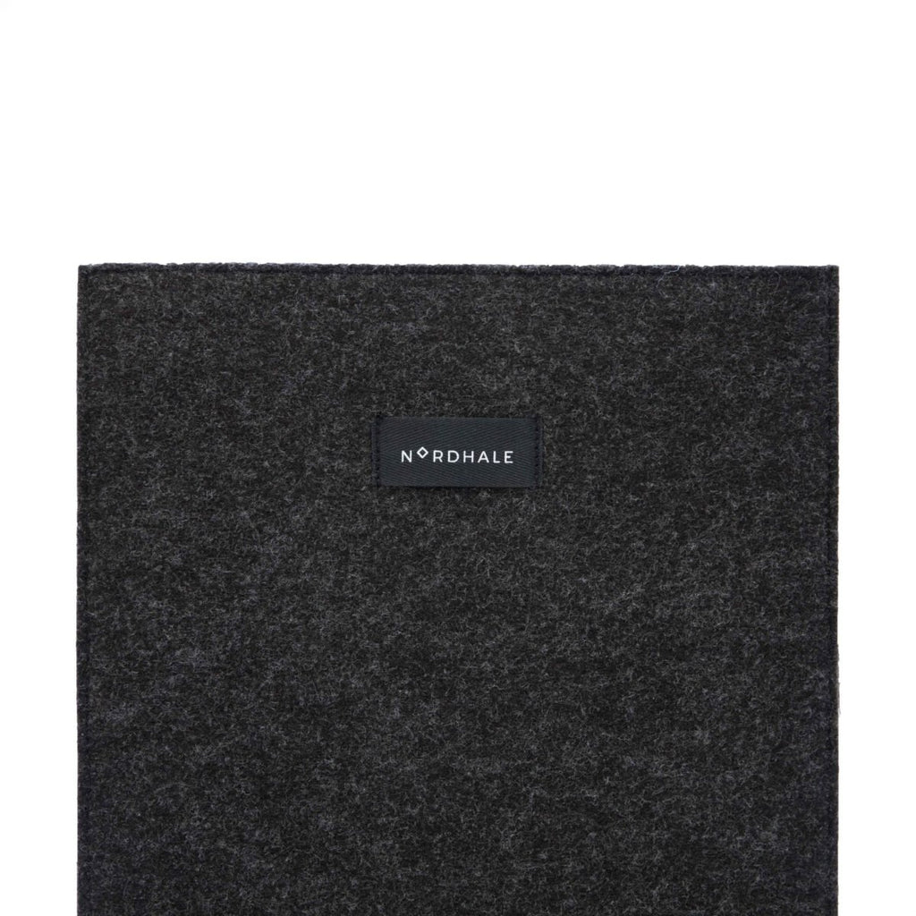 4. Close-up of Nordhale branding on black felt laptop sleeve