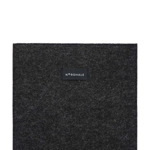 4. Close-up of Nordhale branding on black felt laptop sleeve