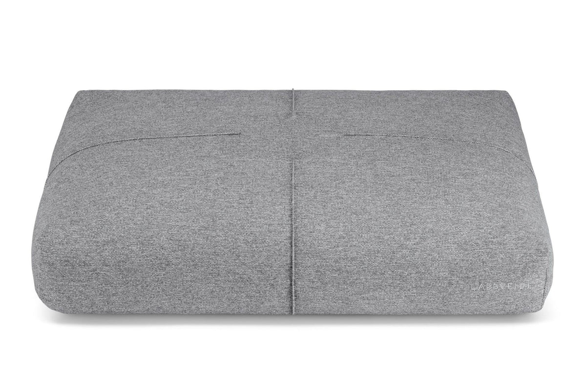 2. Labbvenn Finno cushion in anthracite color with decorative stitching, shown in studio setting highlighting texture and brand logo