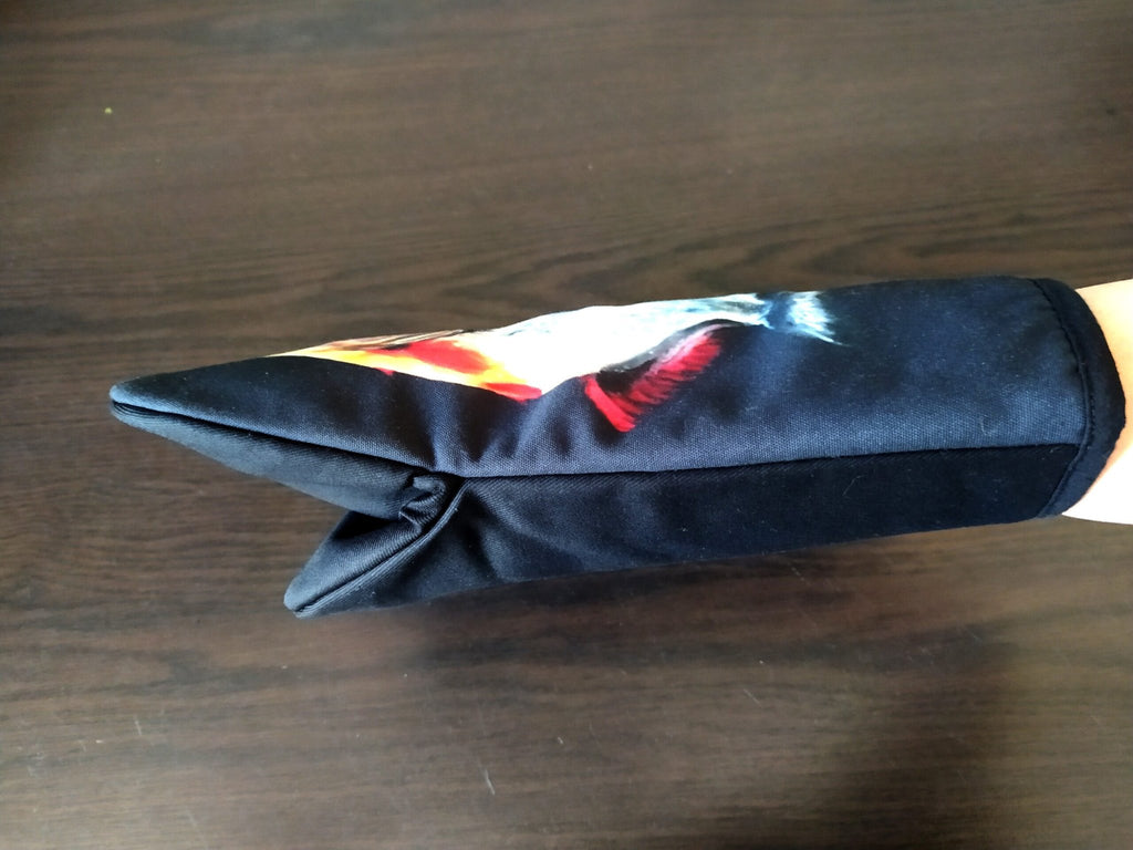3. Side view of black oven mitt with fish painting, highlighting polyester fabric and stitching