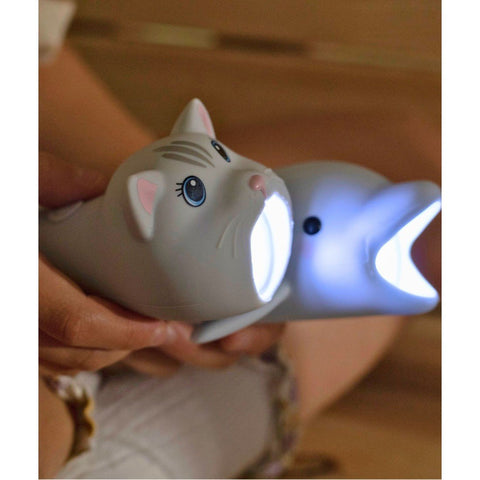 1. Child holding two animal-shaped flashlights, cat and dolphin, both lit