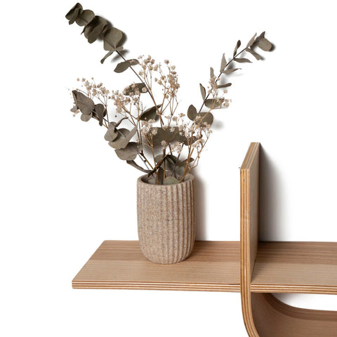 5. Close-up of wooden shelf holding a vase with dried flowers, showcasing natural wood grain