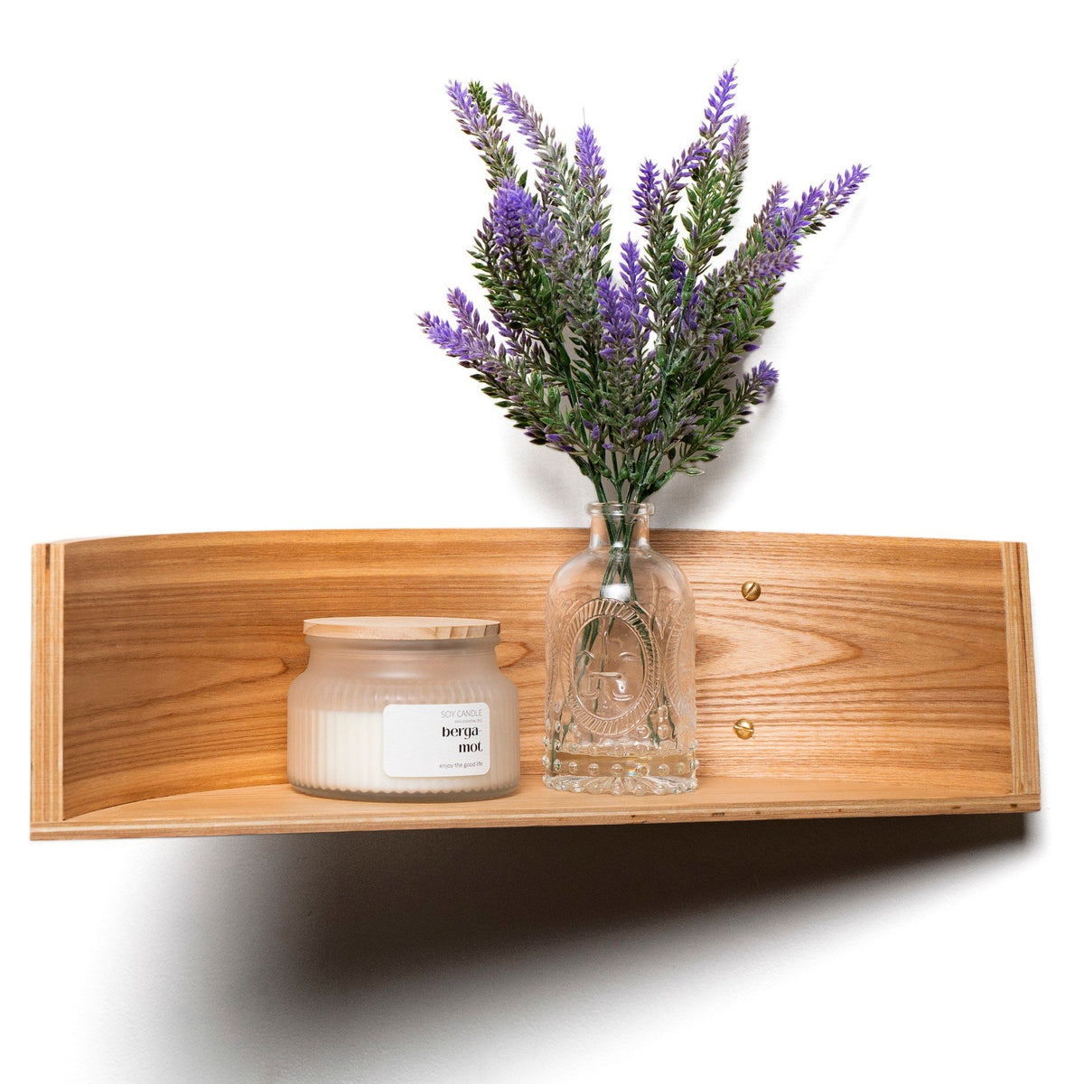 1. Curved-edge floating wooden wall shelf with candle and lavender vase, showcasing natural wood veneer finish