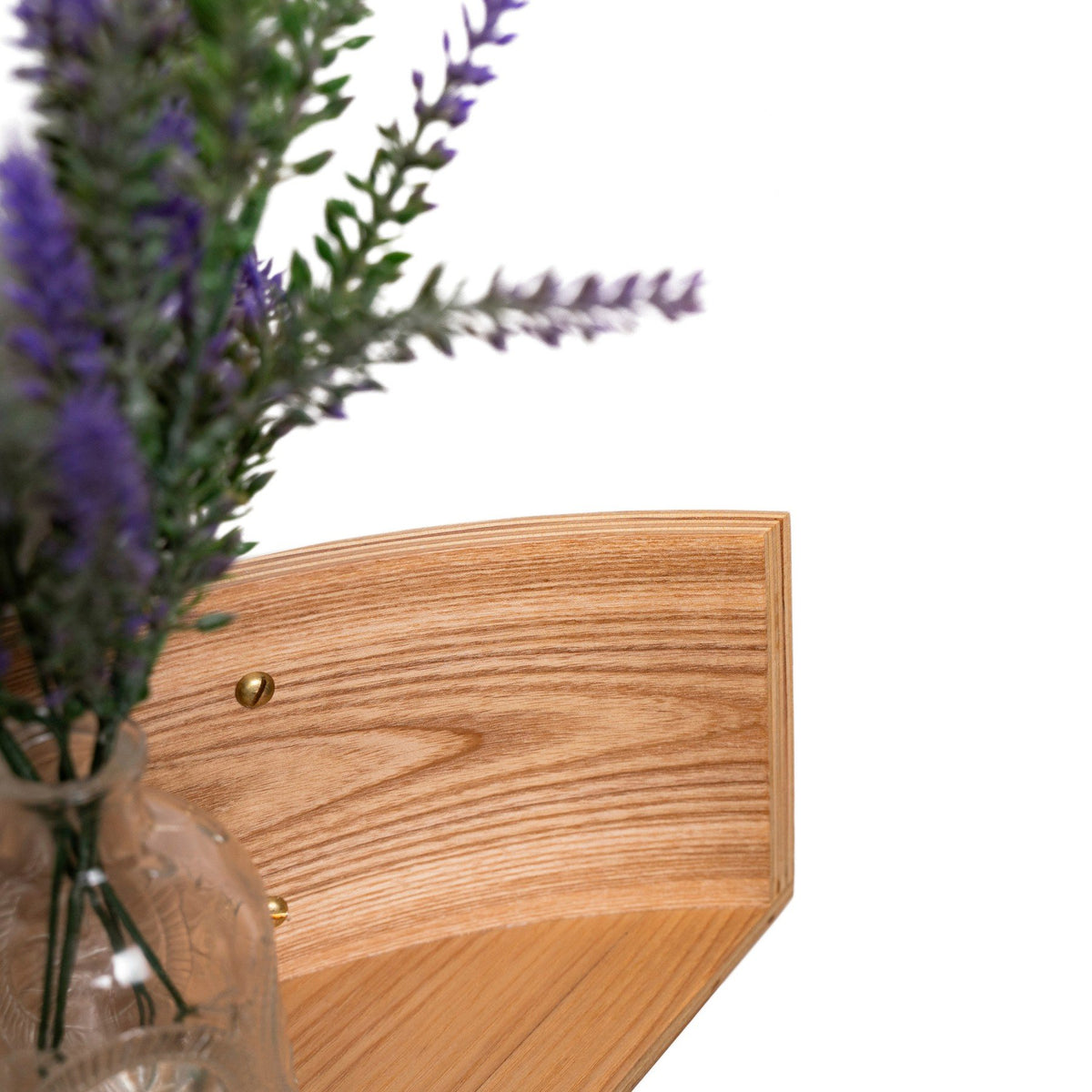 3. Close-up of lavender vase on floating wooden wall shelf, highlighting wood grain and texture