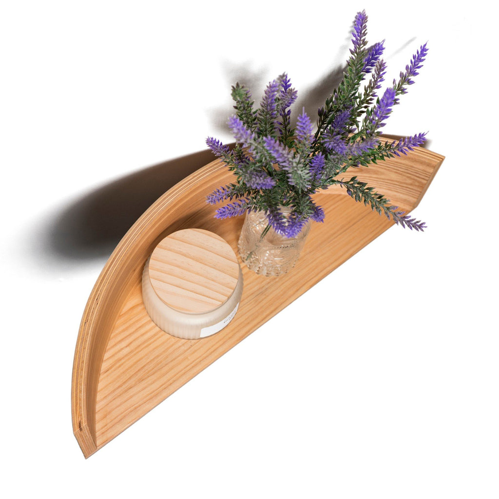4. Top view of floating wooden wall shelf with lavender vase and candle, showing curved design