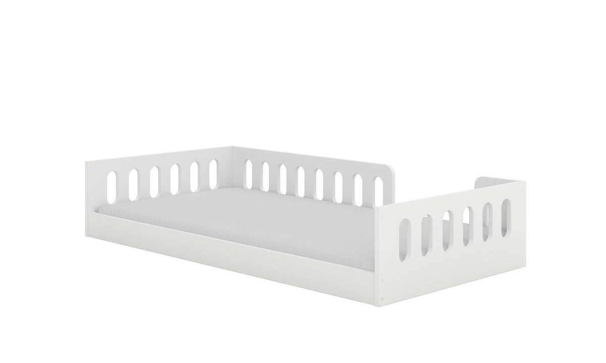 2. White Montessori-inspired kids' floor bed with rounded cut-outs and removable fall protection, shown from side view