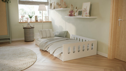 1. Kids' room with white Montessori floor bed, striped bedding, and decorative shelves in a cozy setting