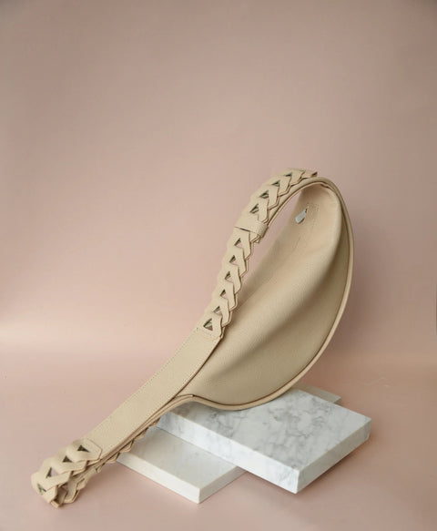 2. Beige Flora Leather Bag by Gerda Retter Design displayed on marble blocks in studio setting