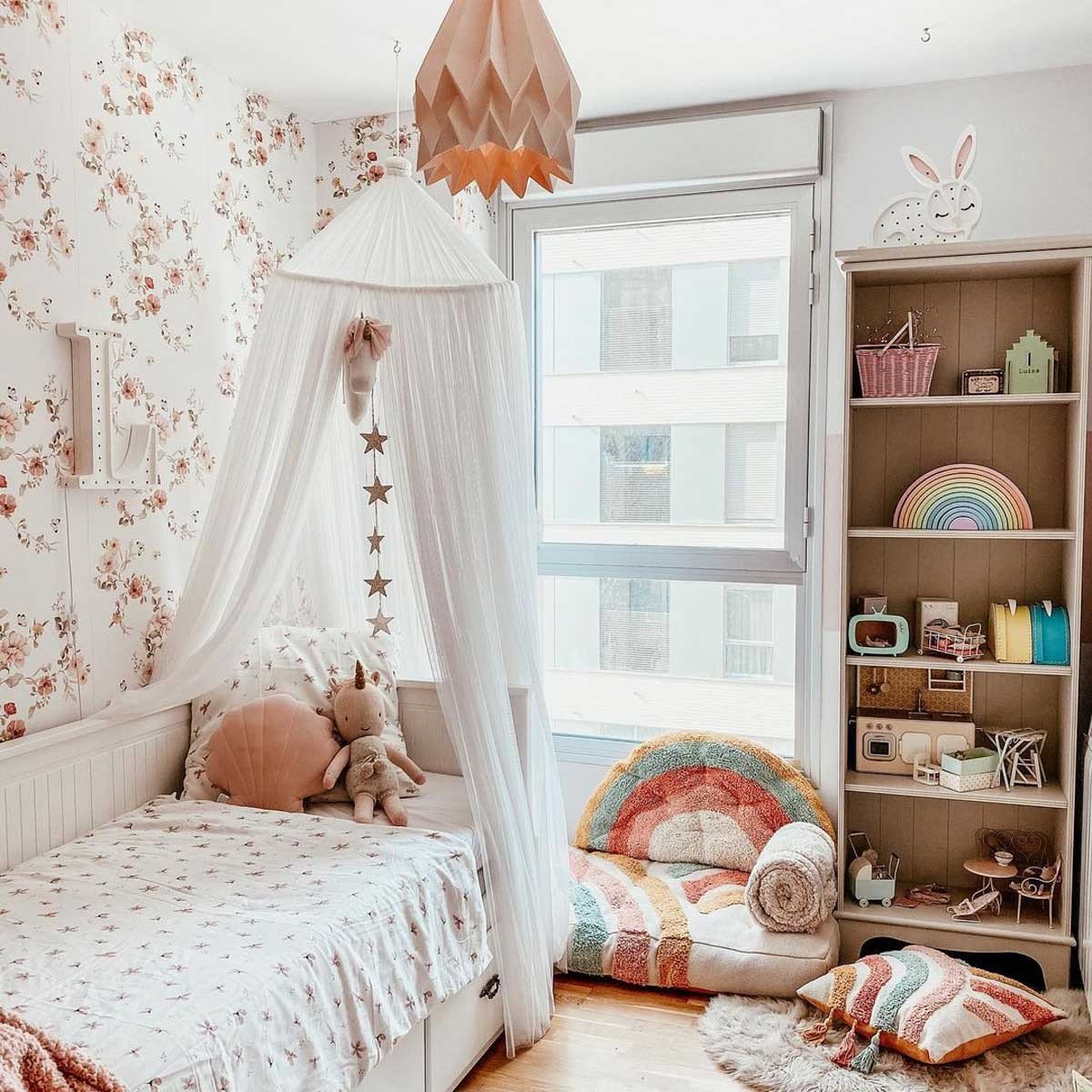 5. Child's room with floral vintage wallpaper, bed with canopy, and colorful decor